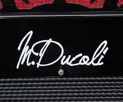 Dettaglio della firma M. Ducoli realizzata con le scritte adesive DecalFont sulla fisarmonica