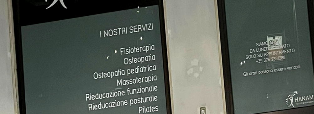 Scritte adesive per vetrine - elenco servizi centro Hanami sulla vetrata